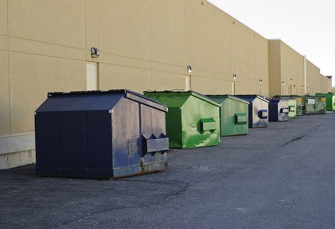 a stack of yellow construction dumpsters on a job site in Appling